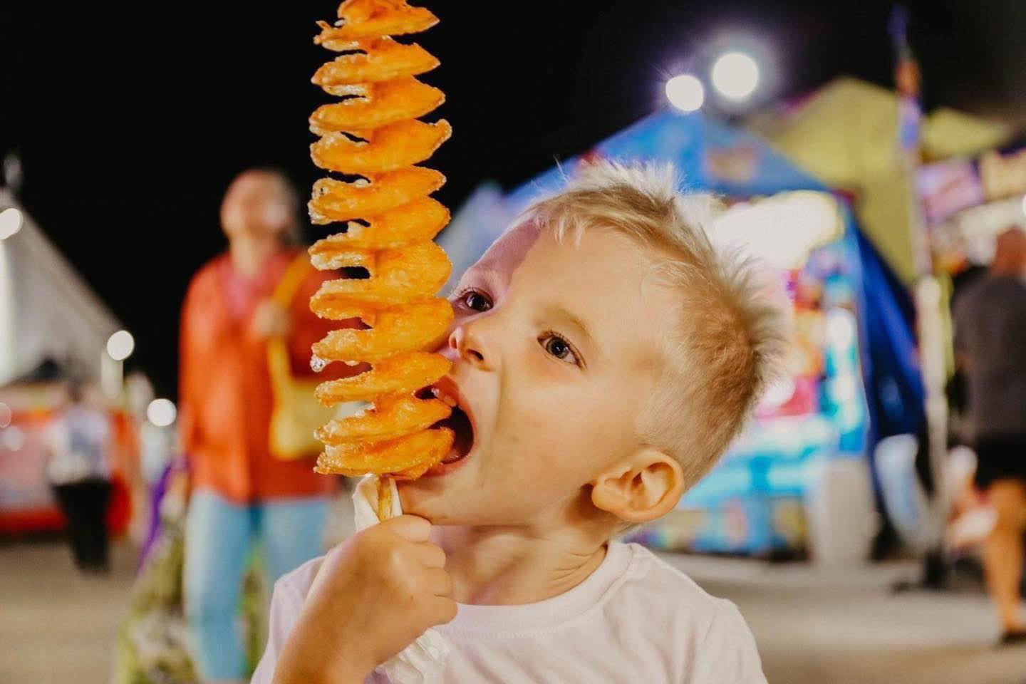 Child enjoying carnival food at event