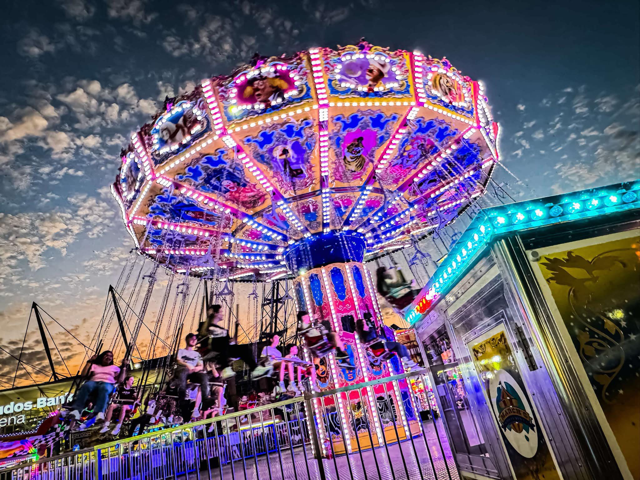 Wave Swinger ride lit up at night